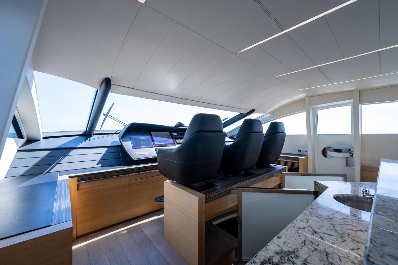 a room with computers and chairs aboard CLAIMS TO FAME Yacht for Sale