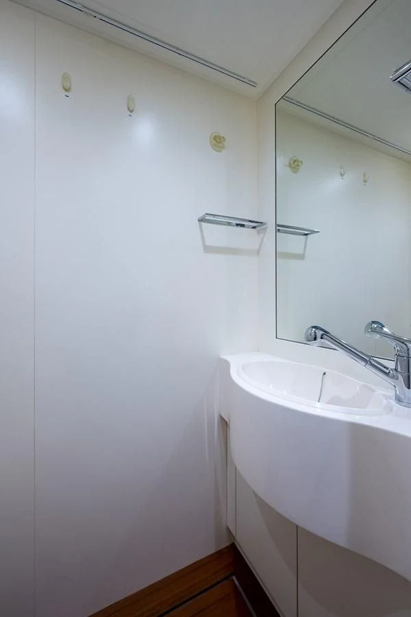 a bathroom with a sink and mirror aboard CLAIMS TO FAME Yacht for Sale