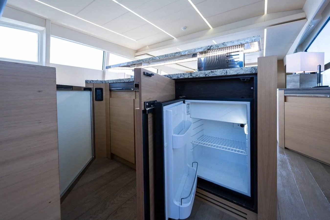 a room with a large refrigerator aboard CLAIMS TO FAME Yacht for Sale