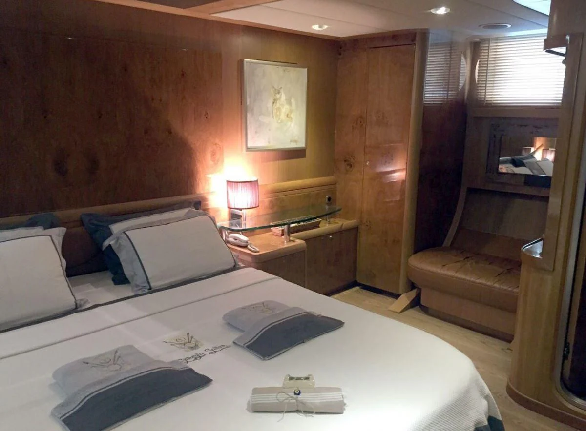 a hotel room with a bed and desk aboard SUHEYLA SULTAN Yacht for Sale