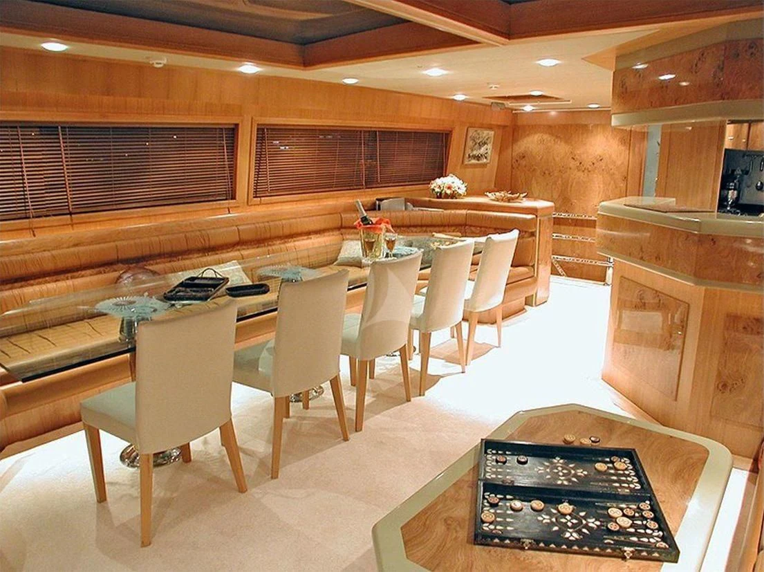 a restaurant with tables and chairs aboard SUHEYLA SULTAN Yacht for Sale