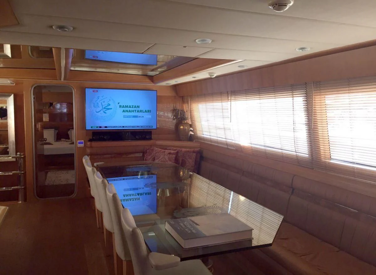 a room with a tv and a table aboard SUHEYLA SULTAN Yacht for Sale