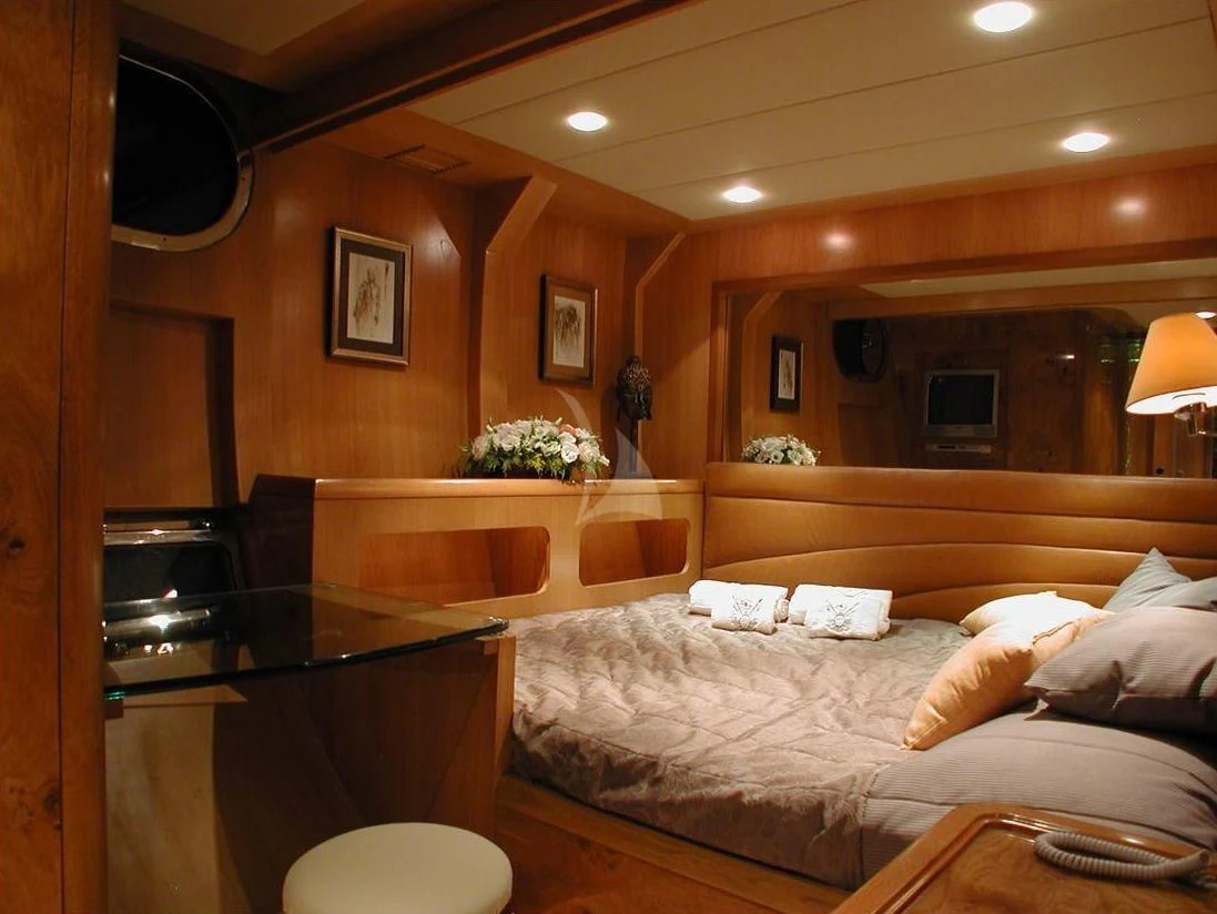 a bedroom with a bed and a desk aboard SUHEYLA SULTAN Yacht for Sale