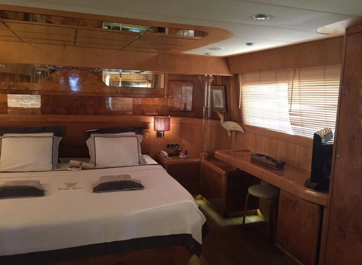 a room with a bed and desk aboard SUHEYLA SULTAN Yacht for Sale