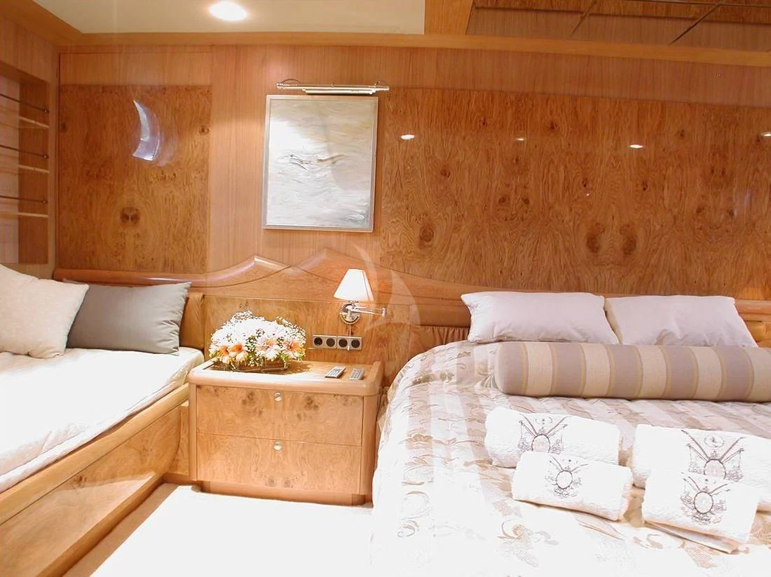 a room with a bed and a table aboard SUHEYLA SULTAN Yacht for Sale
