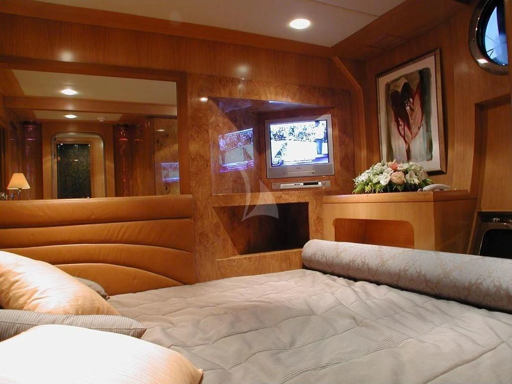 a bed with a television on the wall aboard SUHEYLA SULTAN Yacht for Sale