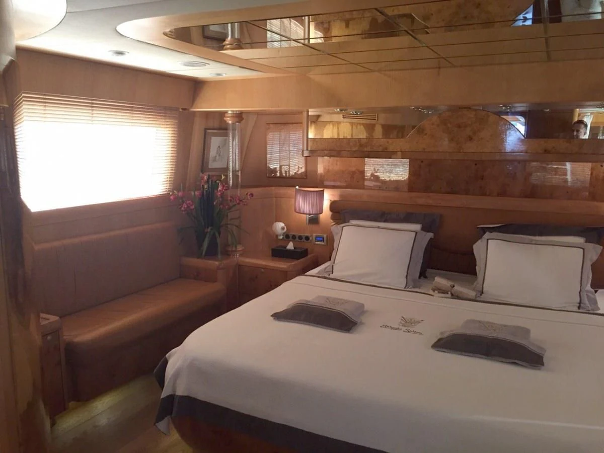 a room with a bed and a couch aboard SUHEYLA SULTAN Yacht for Sale
