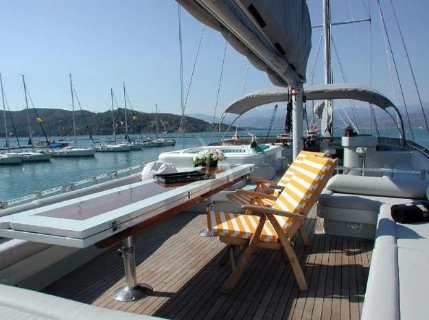a deck with a chair and boats on it aboard SUHEYLA SULTAN Yacht for Sale