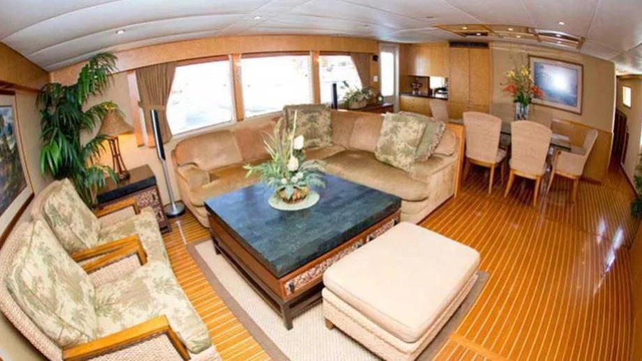 a living room with a table and couches aboard SHERAZADE Yacht for Sale