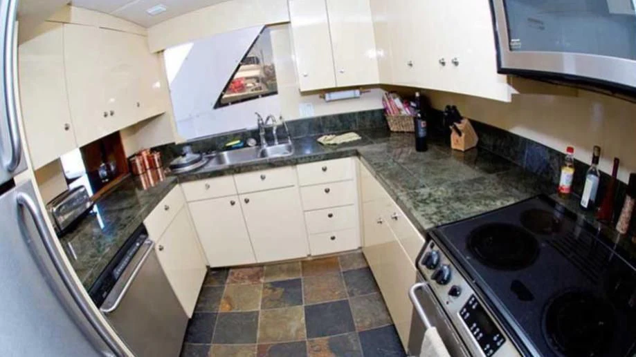 a kitchen with white cabinets aboard SHERAZADE Yacht for Sale