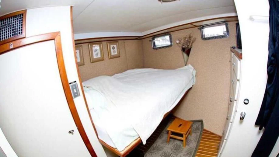 a room with a bed and a desk aboard SHERAZADE Yacht for Sale
