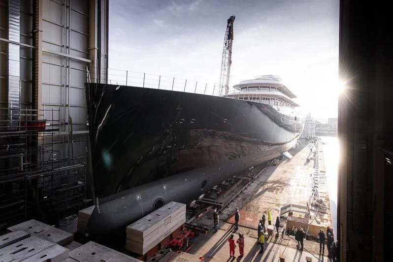 a large black object with a group of people around it aboard LIVA Yacht for Sale