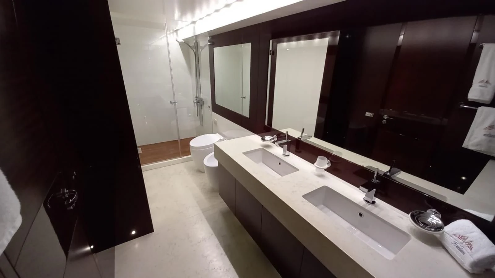 a bathroom with sinks and mirrors aboard FREEDOM Yacht for Sale
