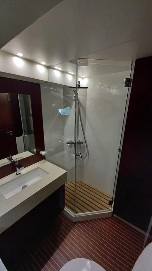 a bathroom with a glass shower aboard FREEDOM Yacht for Sale