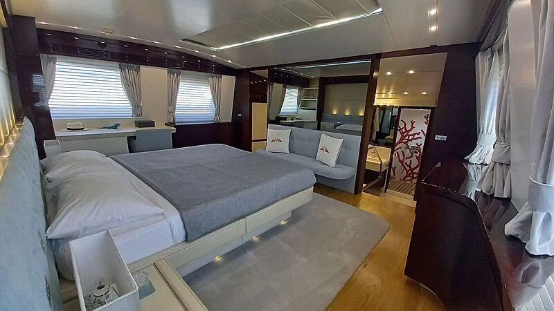 a room with a bed and a couch aboard FREEDOM Yacht for Sale