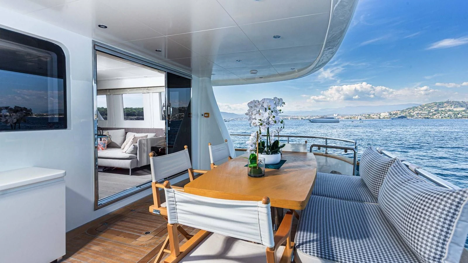 a table and chairs on a deck aboard T9 Yacht for Sale