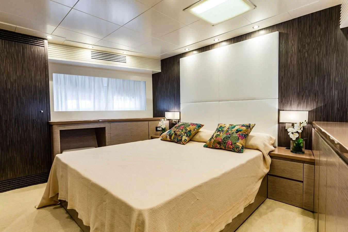 a bedroom with a bed and a desk aboard T9 Yacht for Sale