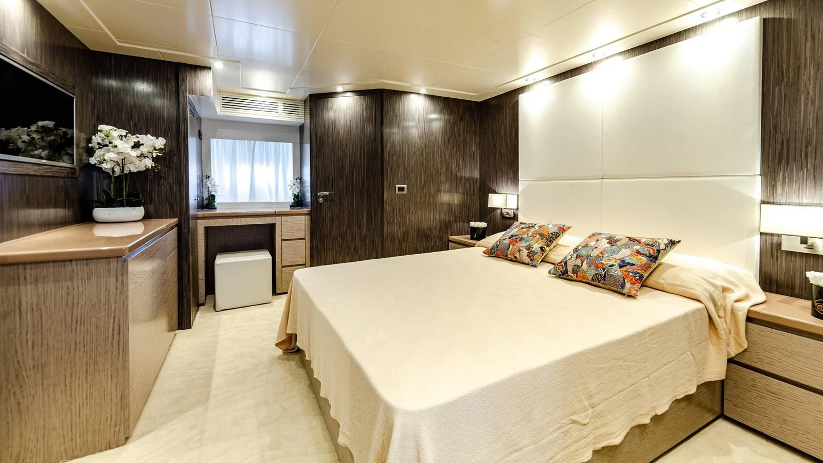 a room with a bed and desk aboard T9 Yacht for Sale