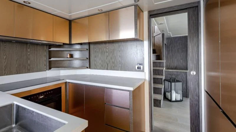 a kitchen with wooden cabinets aboard T9 Yacht for Sale