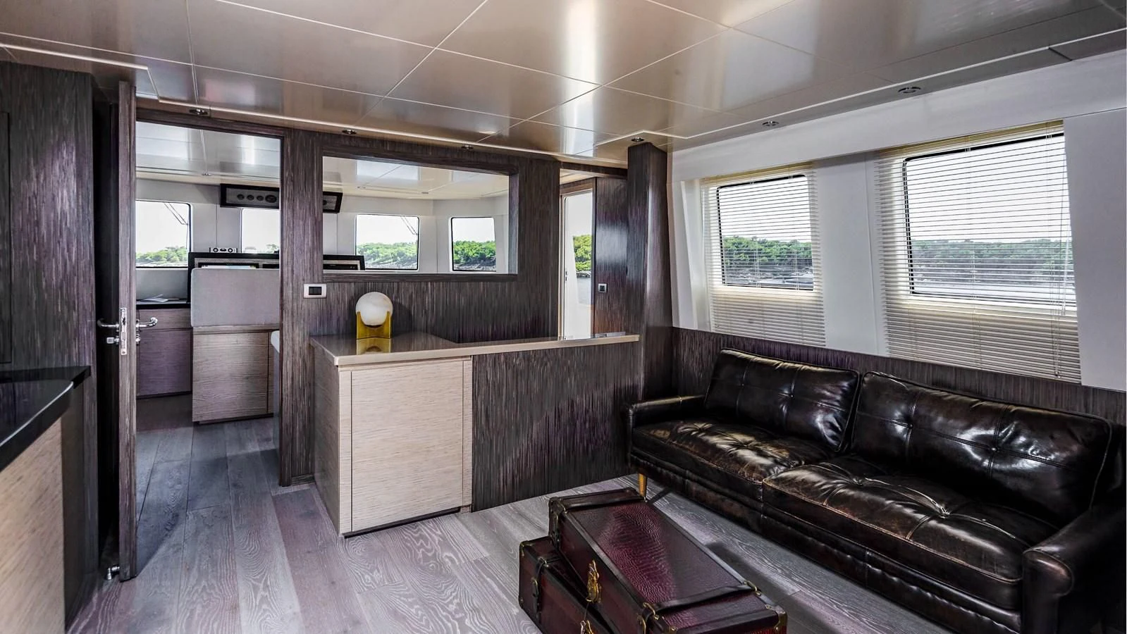 a living room with a leather couch aboard T9 Yacht for Sale