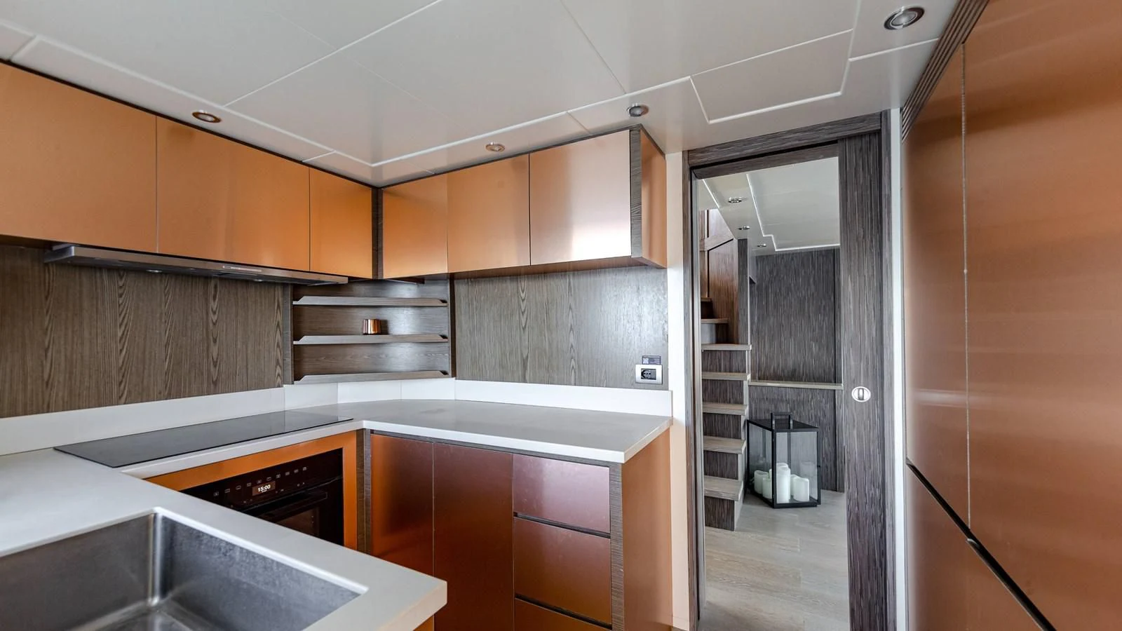 a kitchen with wooden cabinets aboard T9 Yacht for Sale