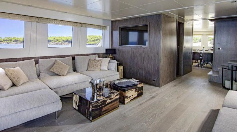 a living room with a couch and a coffee table aboard T9 Yacht for Sale