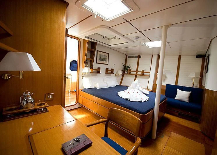 a room with a bed and a desk aboard BAIURDO VI Yacht for Sale