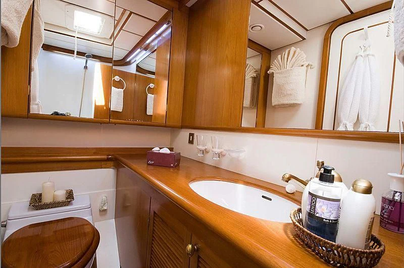 a bathroom with a sink and a mirror aboard BAIURDO VI Yacht for Sale