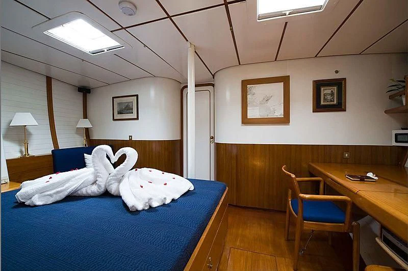 a room with a desk and a bed aboard BAIURDO VI Yacht for Sale
