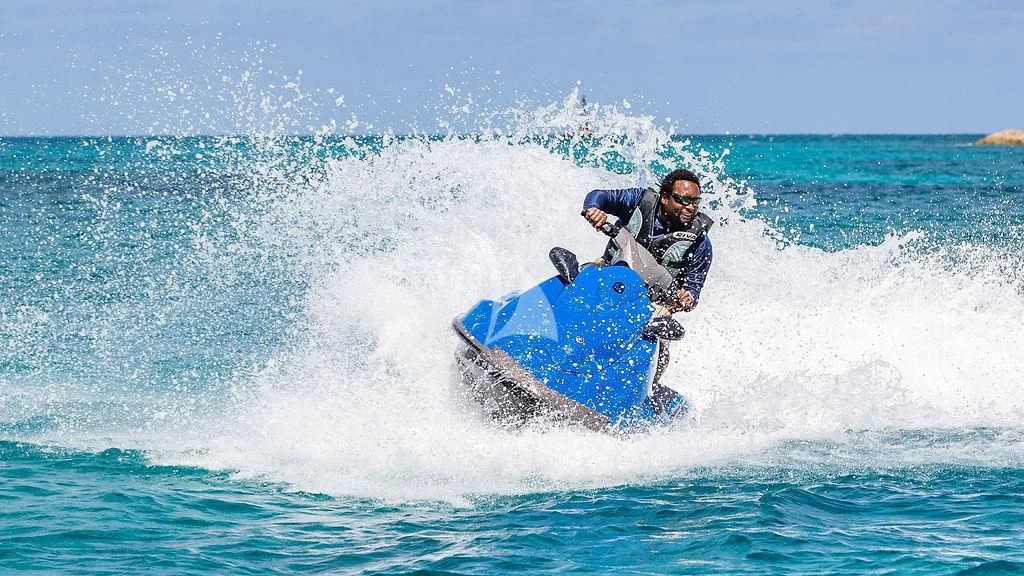 a man riding a surfboard aboard ALEXANDRA JANE Yacht for Sale