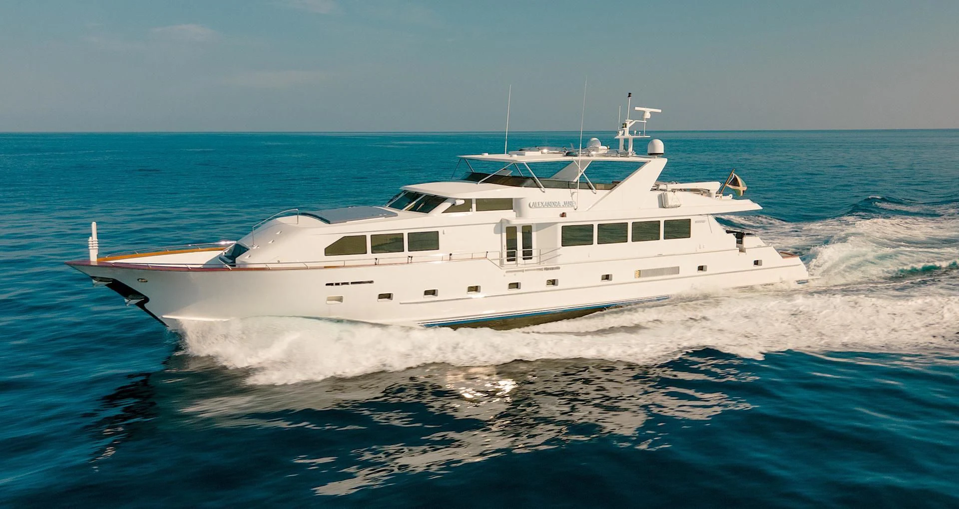 a white boat on the water aboard ALEXANDRA JANE Yacht for Sale