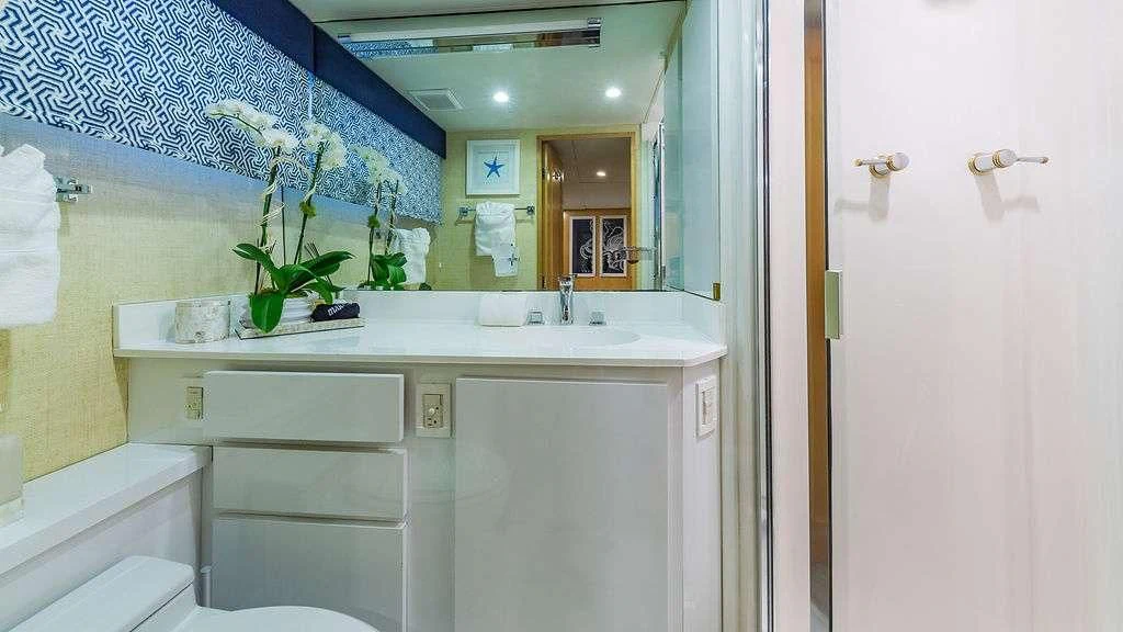 a bathroom with a sink and a mirror aboard ALEXANDRA JANE Yacht for Sale