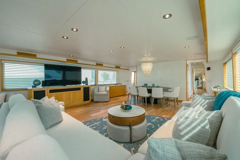 a living room with a large sofa and a coffee table aboard ALEXANDRA JANE Yacht for Sale