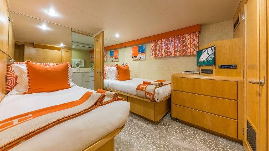 a room with a bed and a television aboard ALEXANDRA JANE Yacht for Sale