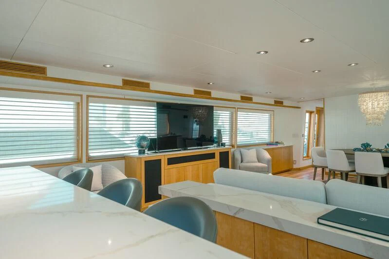a room with a couch and a table and chairs aboard ALEXANDRA JANE Yacht for Sale