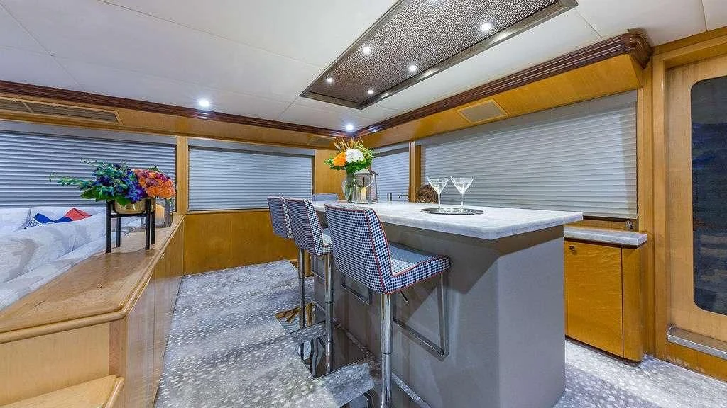 a room with a table and chairs aboard ALEXANDRA JANE Yacht for Sale