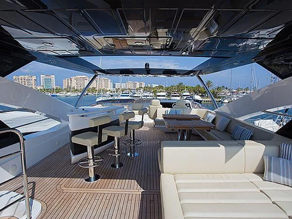 a boat deck with tables and chairs aboard X-ELEVEN Yacht for Sale
