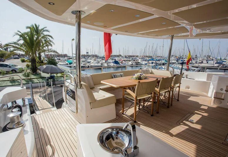 a room with a table and chairs aboard X-ELEVEN Yacht for Sale