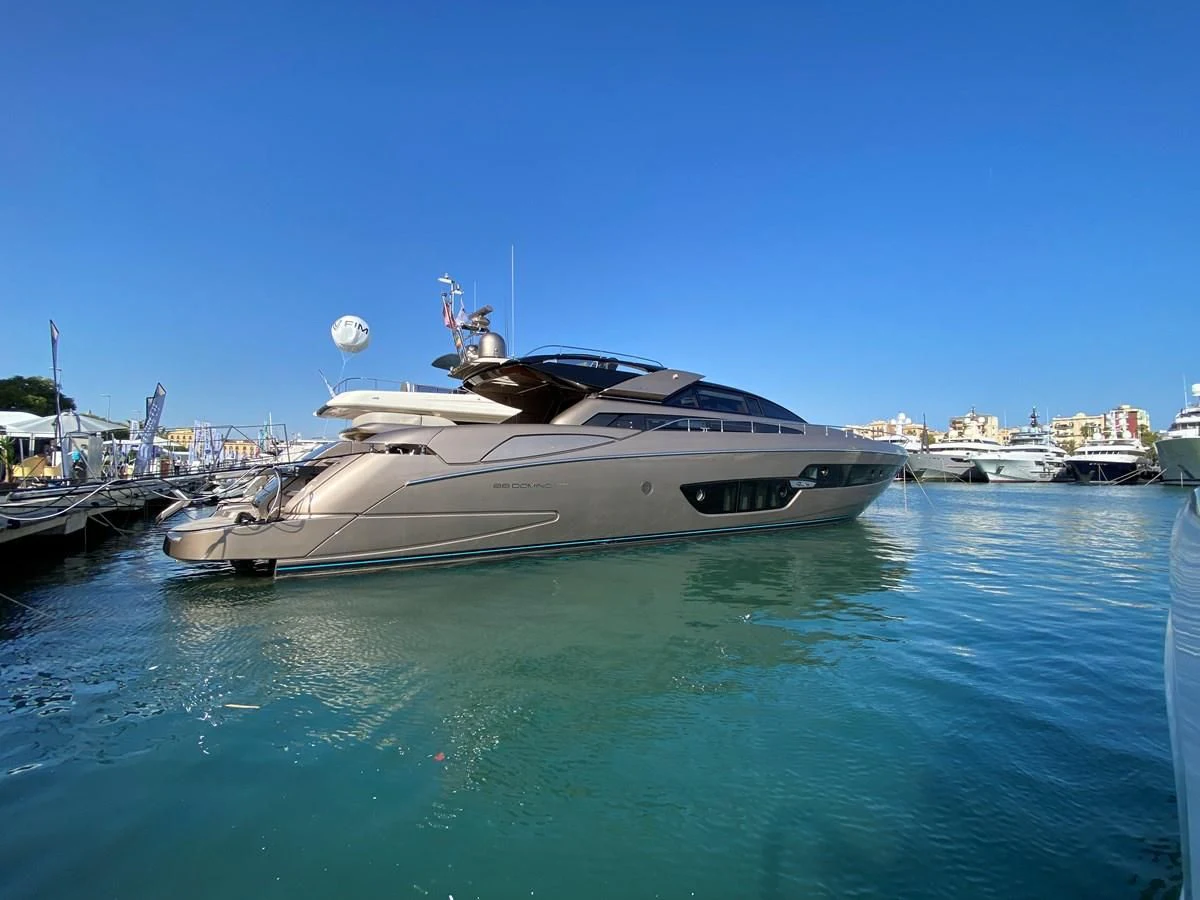 a boat in the water with USS Midway Museum in the background aboard DONNA SANTA Yacht for Sale