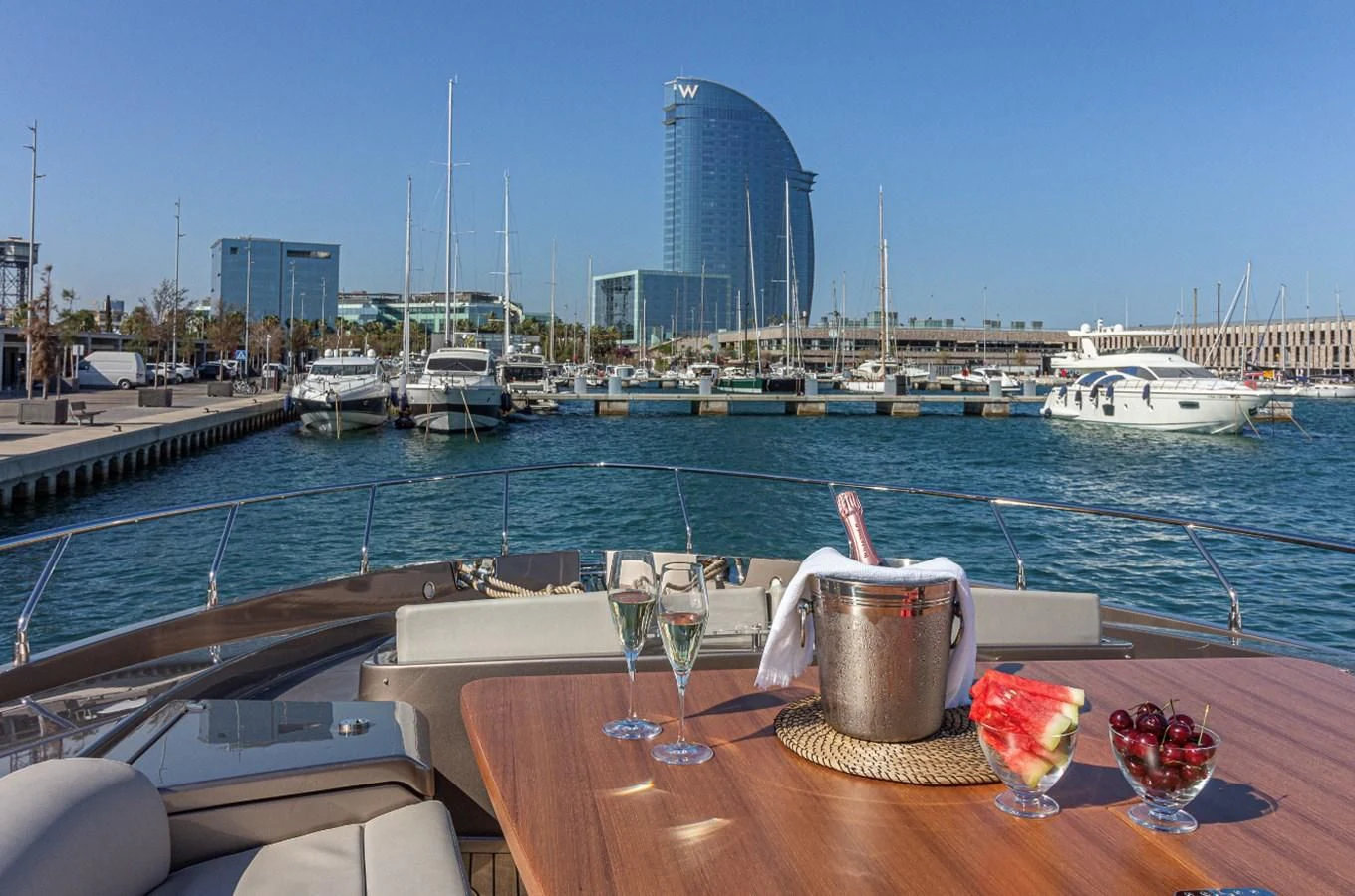 a table with glasses and a candle on it by a body of water aboard DONNA SANTA Yacht for Sale