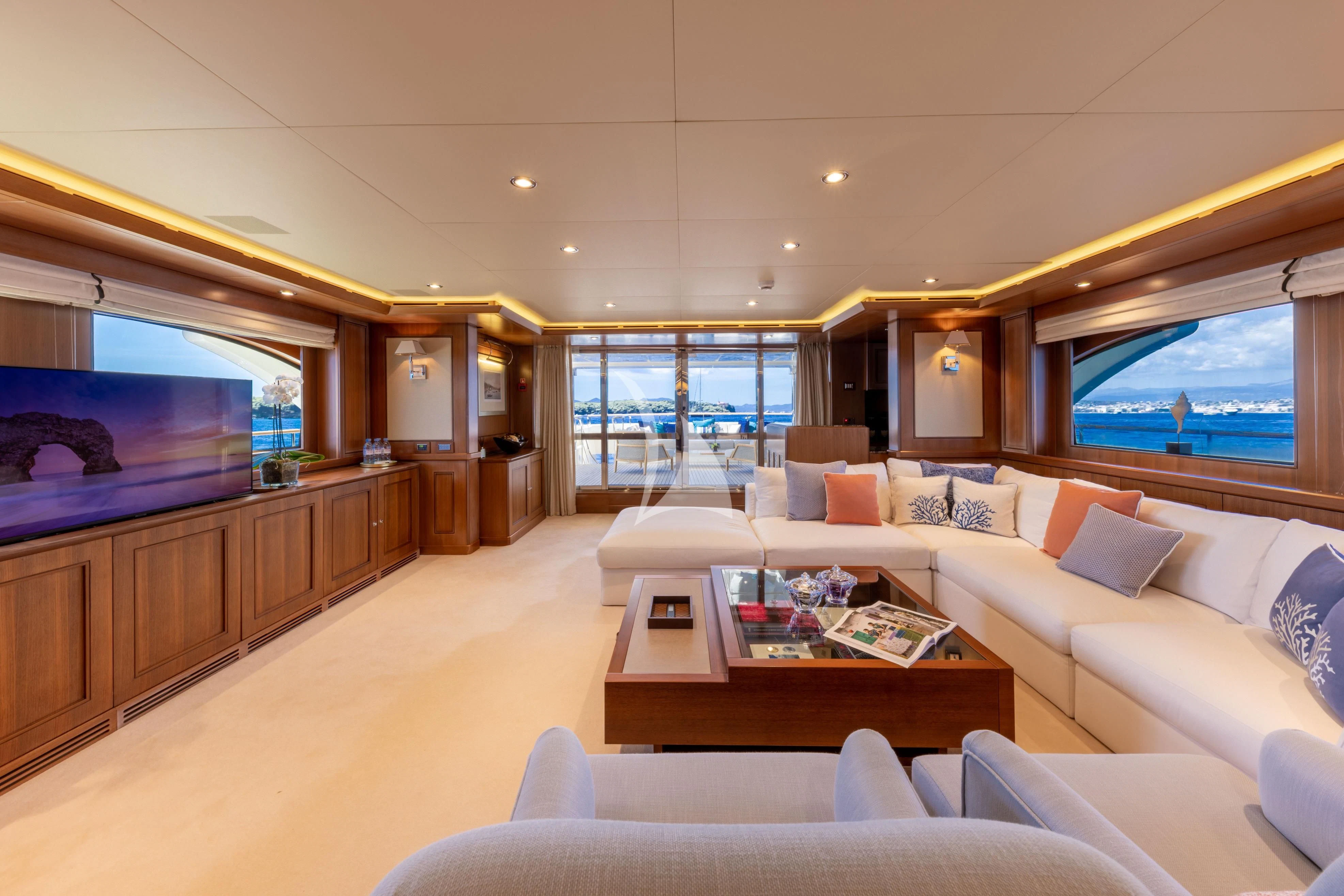 a living room with a large tv aboard O'LION Yacht for Sale
