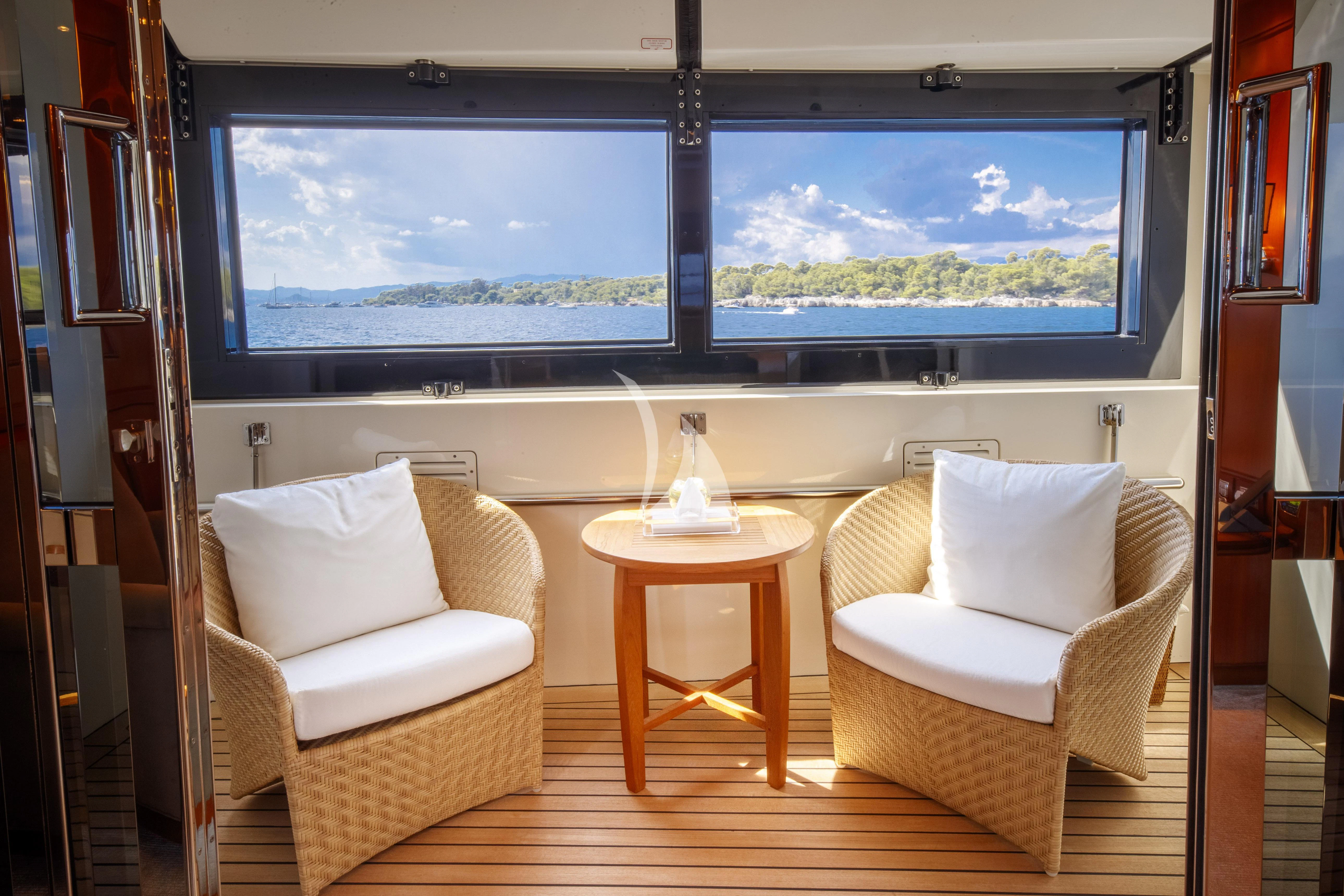 a room with a table and chairs aboard O'LION Yacht for Sale