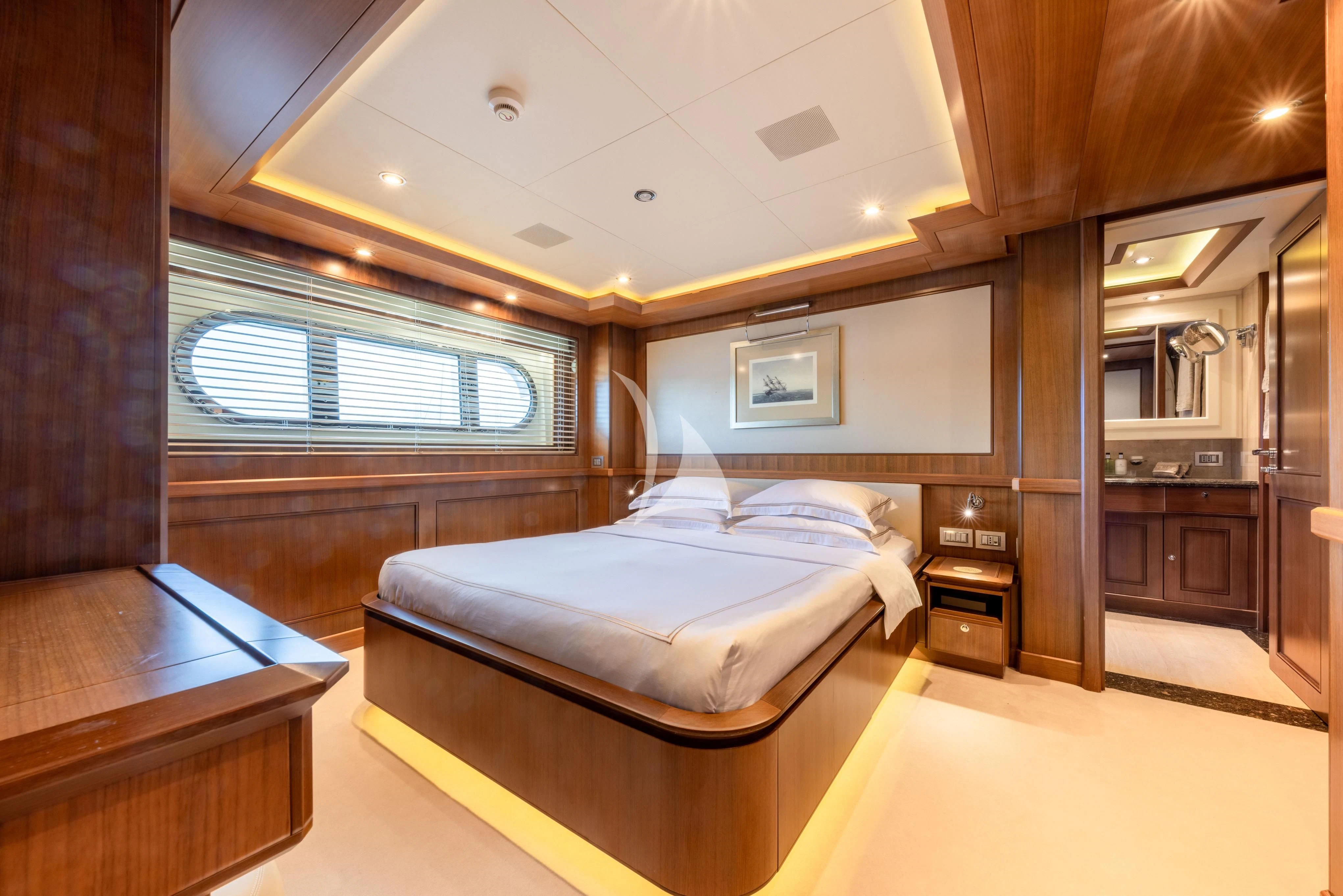 a room with a bed and a desk aboard O'LION Yacht for Sale