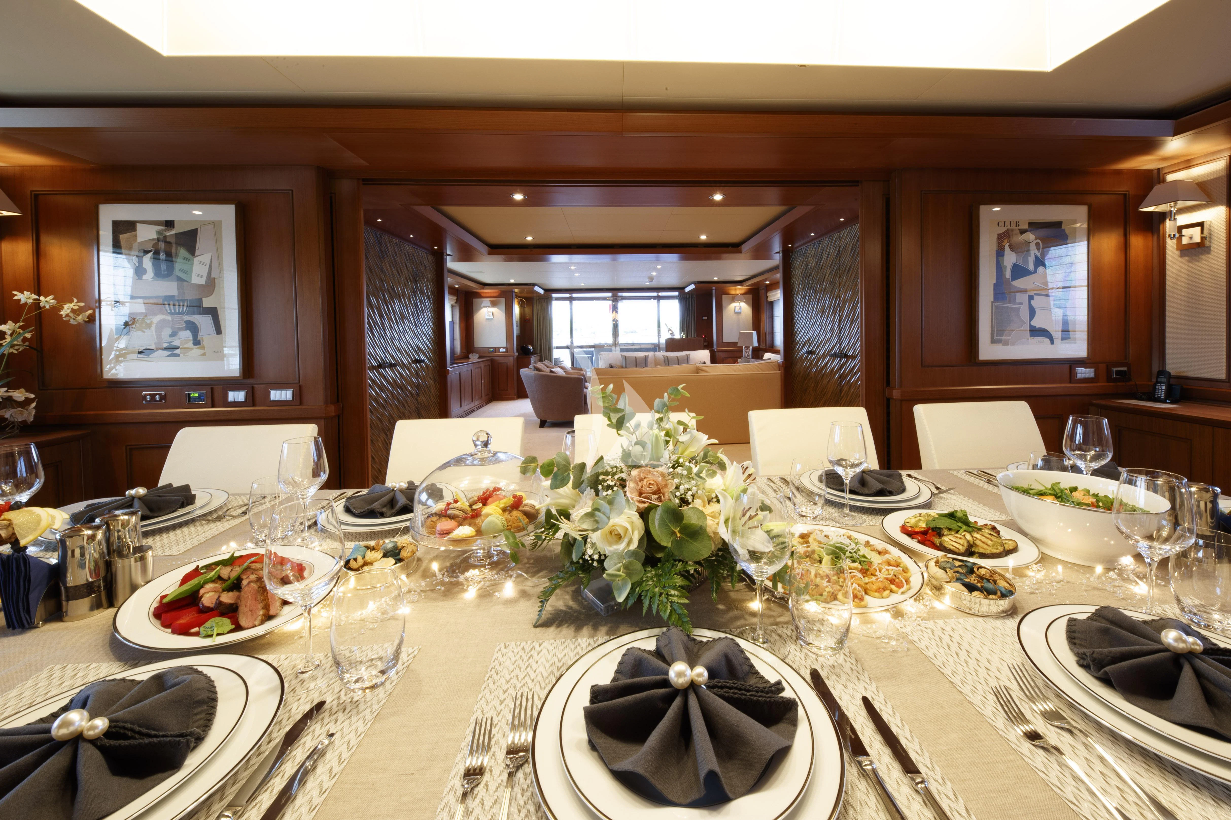 a table with plates and food on it aboard O'LION Yacht for Sale