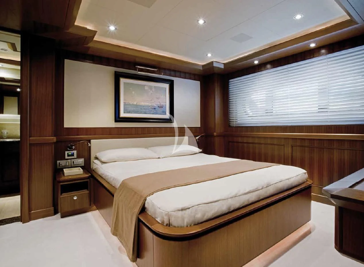 a room with a bed and a television aboard O'LION Yacht for Sale