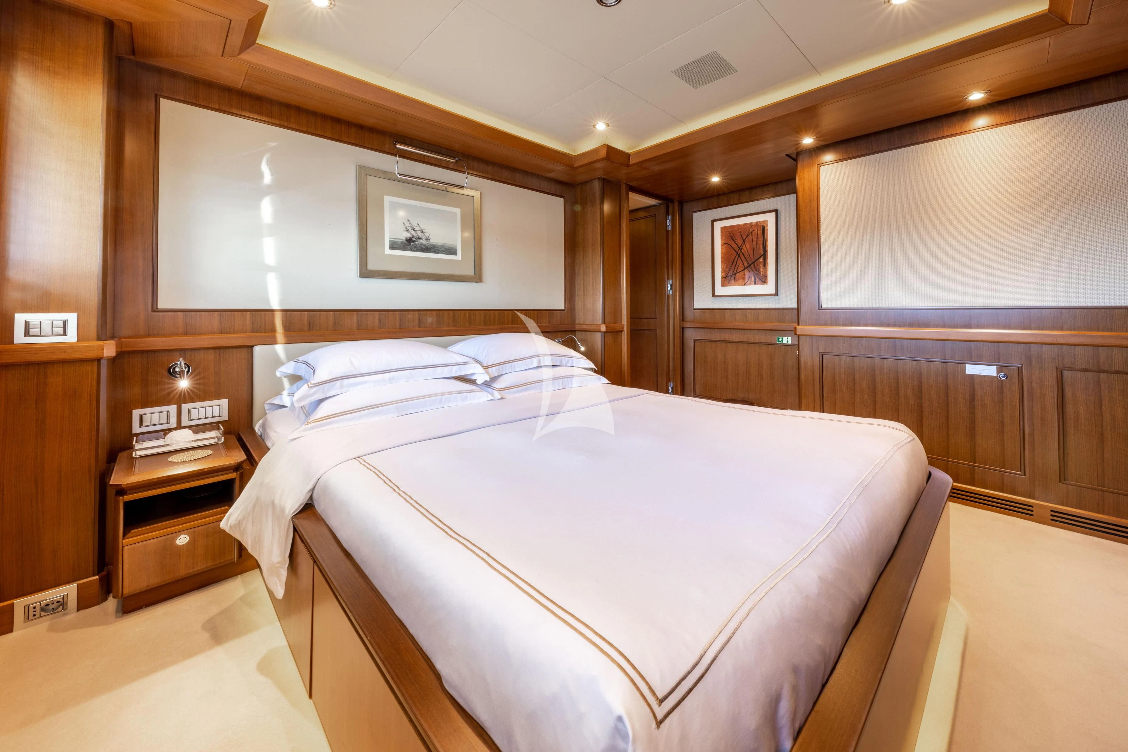 a bedroom with a bed and a desk aboard O'LION Yacht for Sale