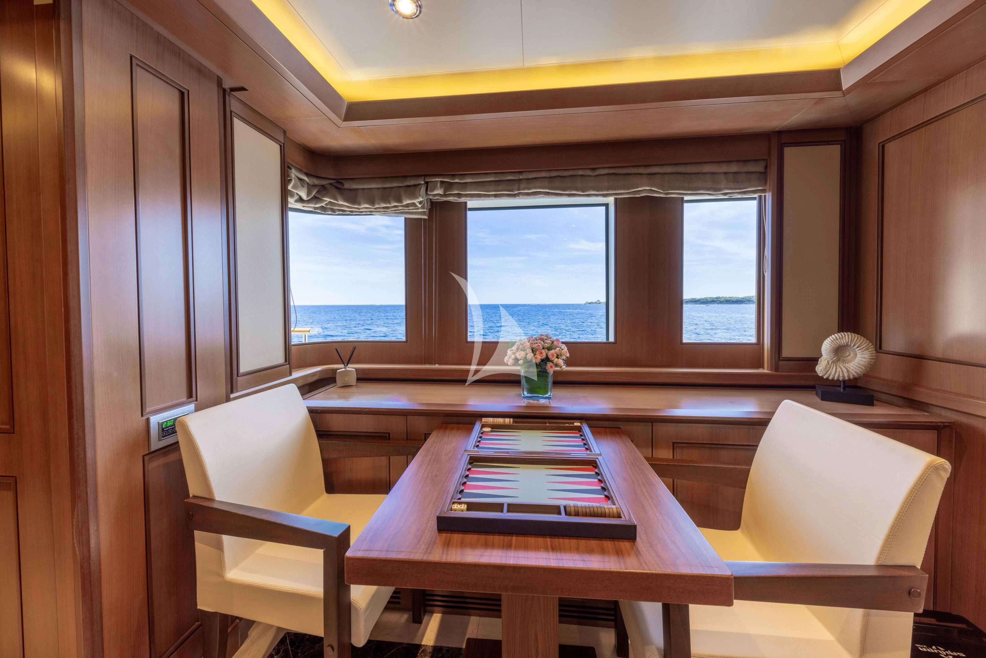 a dining table in a room aboard O'LION Yacht for Sale