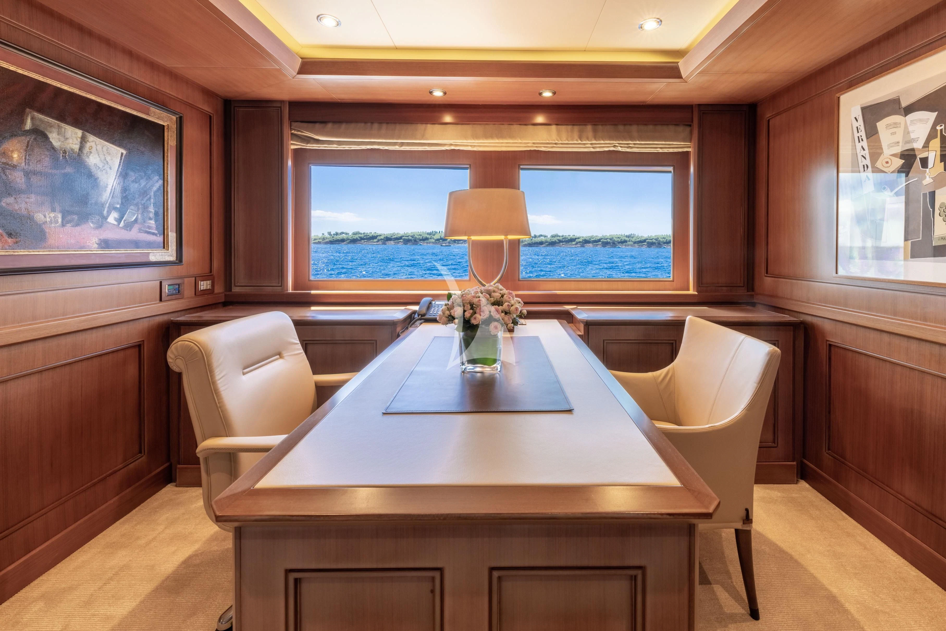 a room with a table and a window aboard O'LION Yacht for Sale