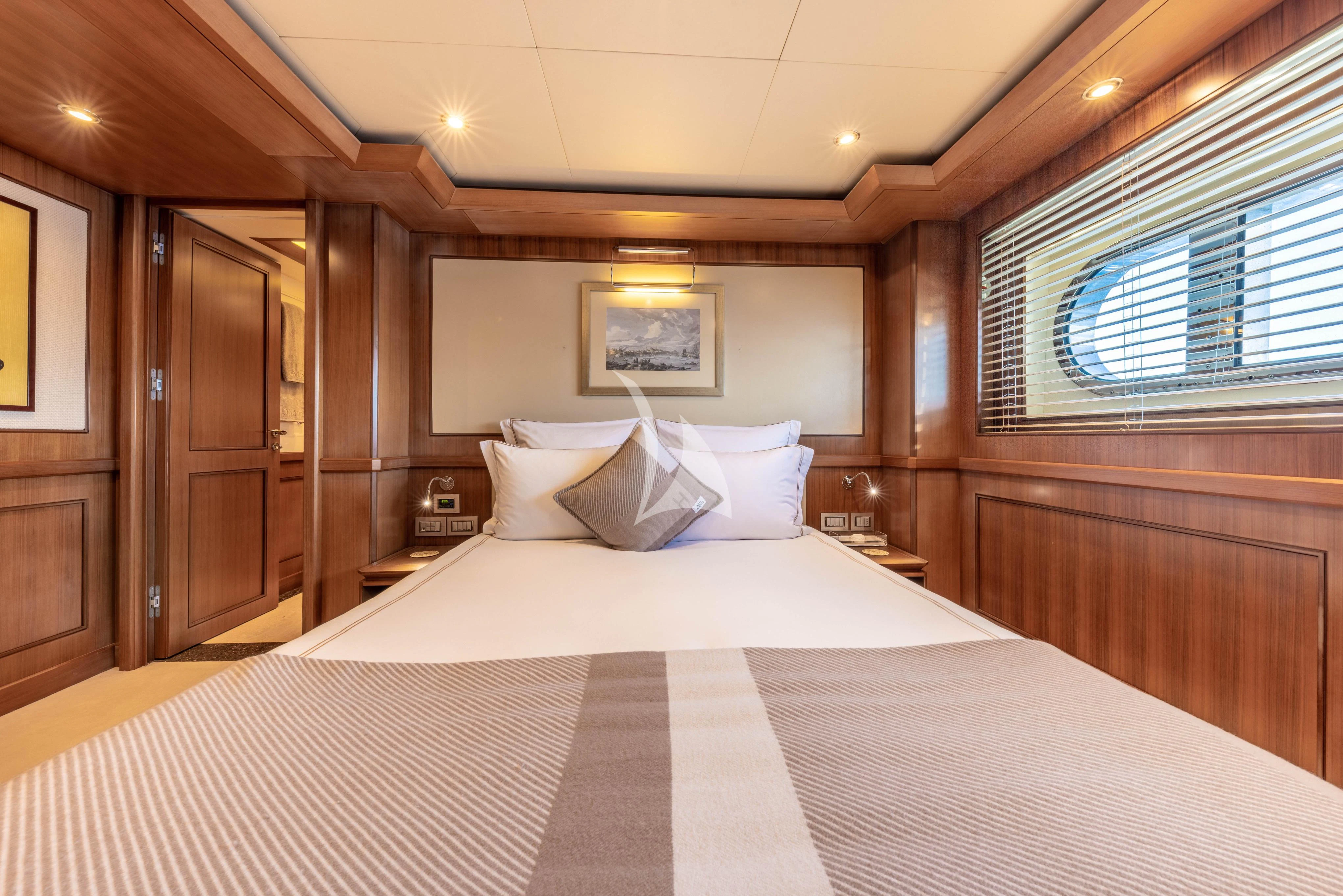 a bed with white sheets aboard O'LION Yacht for Sale