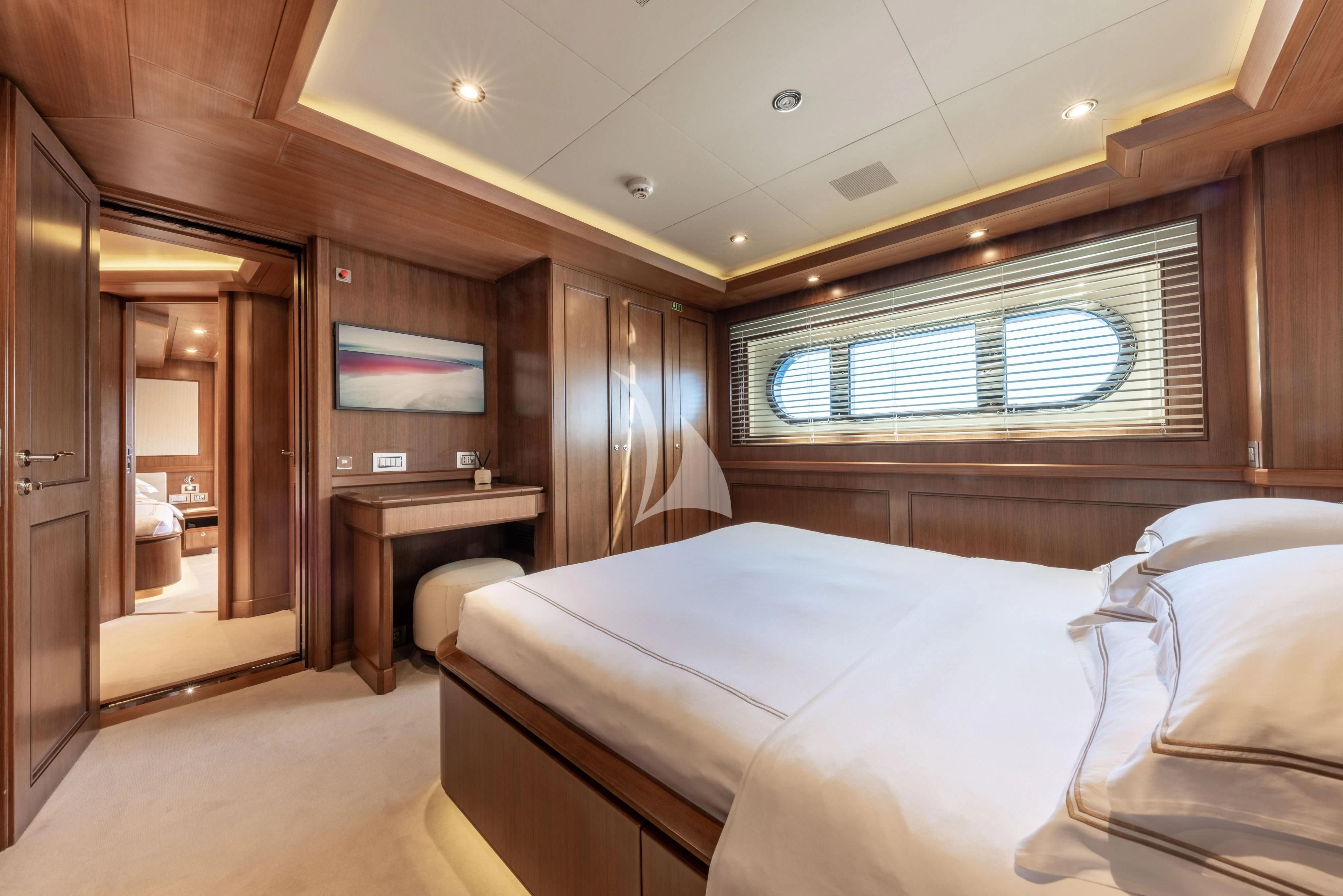 a room with a bed and a desk aboard O'LION Yacht for Sale